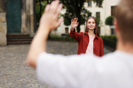 Goodbye. Man waving to his girlfriend outdoors, selective focusの写真素材
