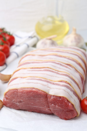 Piece of raw beef meat, tomatoes and spices on table, closeupの写真素材