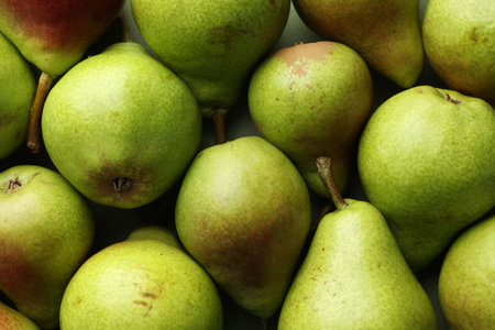 Many whole ripe pears as background, closeup