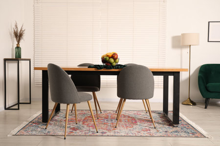 Bowl of fruits on wooden table in dining room. Interior design