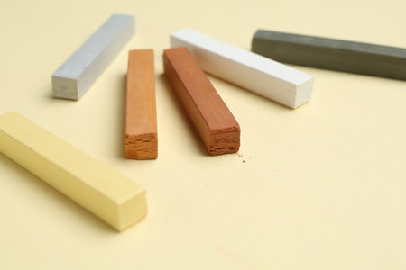 Many colorful chalk pastels on beige background, closeupの写真素材