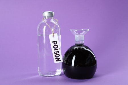Glass bottles with poisons on violet backgroundの写真素材