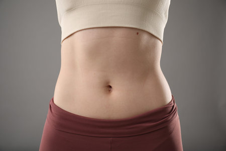Woman after weight loss on grey background, closeupの写真素材