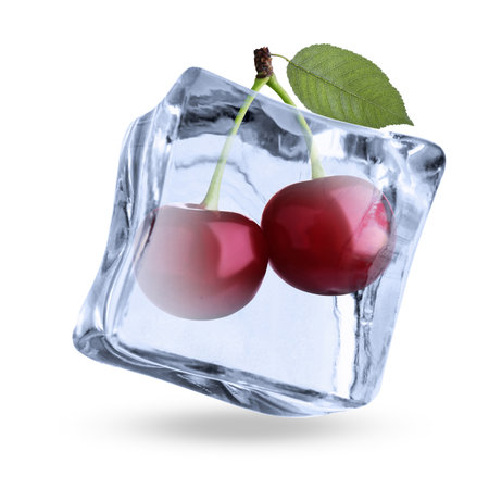 Fresh cherries in clear ice cube isolated on whiteの写真素材