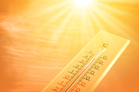 Extremely high temperature on thermometer against orange sky on sunny day. Severely hot summer...