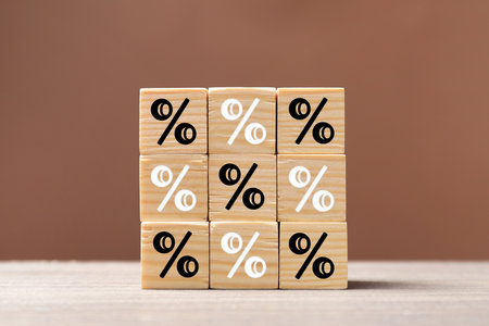 Percent signs on wooden cubes against brown backgroundの写真素材