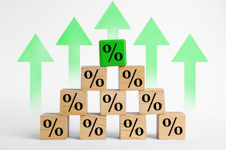 Percent signs on wooden cubes and arrows against white backgroundの写真素材