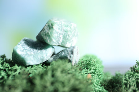 Healing stones on green moss against blurred background, closeup. Space for textの写真素材