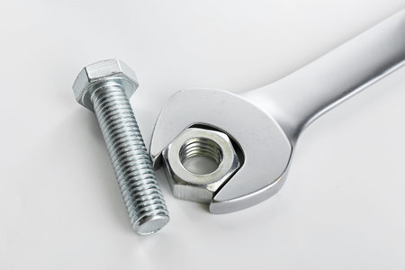 Metal wrench, bolt and nut on white background, closeupの写真素材