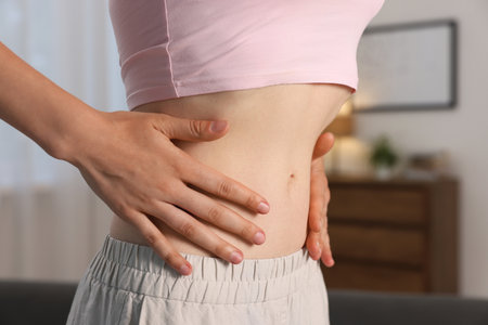 Woman with flat belly at home, closeupの写真素材