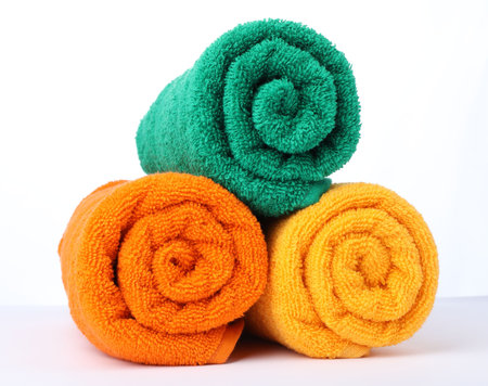 Colorful rolled terry towels isolated on whiteの写真素材