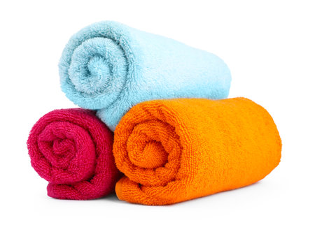 Colorful rolled terry towels isolated on whiteの写真素材