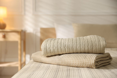 Stack of clean towels on bed lines at home, closeupの写真素材