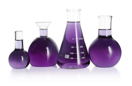 Laboratory glassware with violet liquid isolated on white