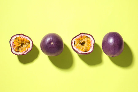 Fresh passion fruits on pale green background, flat layの写真素材