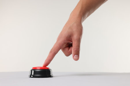 Man pressing red button on white background, closeupの写真素材