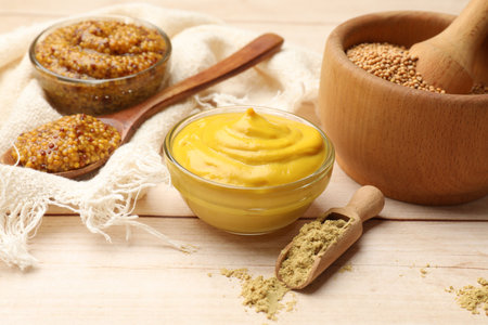 Different types of mustard on wooden table, closeupの写真素材