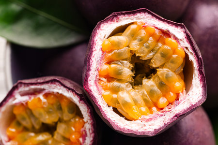 Fresh passion fruits and green leaf in bowl, top viewの写真素材