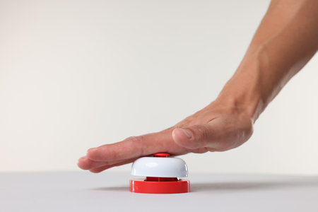 Man pressing red button on white background, closeupの写真素材