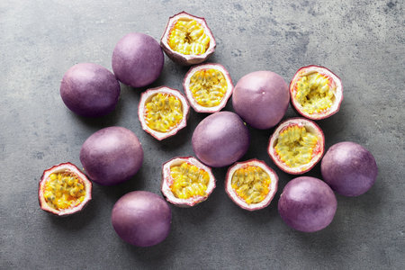 Fresh passion fruits on gray table, flat lay