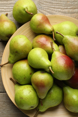 Fresh ripe pears on wooden table, flat layの写真素材
