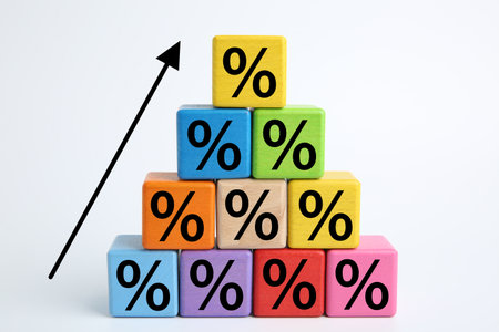 Percent signs on colorful cubes and arrow against white backgroundの写真素材