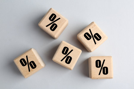 Wooden cubes with percent signs on gray background, top viewの写真素材
