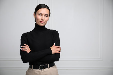 Portrait of beautiful woman near white wall. Space for textの写真素材