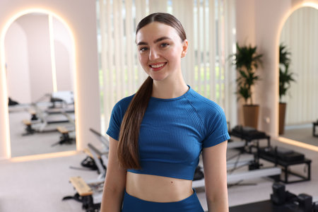 Happy woman wearing sportswear in pilates studioの写真素材