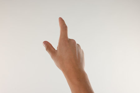Man touching something on light grey background, closeupの写真素材