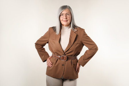 Portrait of beautiful senior woman on light backgroundの写真素材