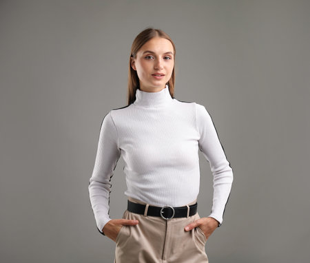 Portrait of confident woman on gray backgroundの写真素材