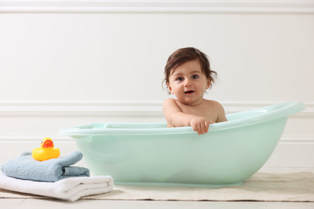 Cute little baby bathing in tub at homeの写真素材
