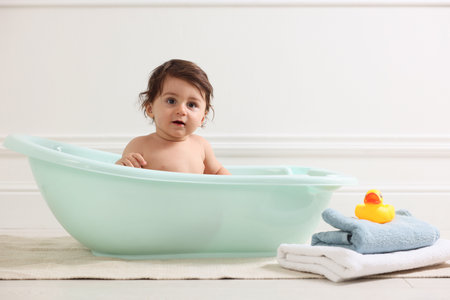 Cute little baby bathing in tub at homeの写真素材
