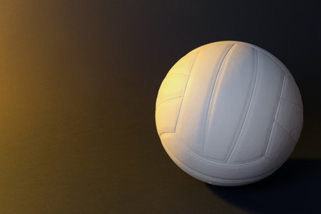 White volleyball ball on dark background. Space for textの写真素材