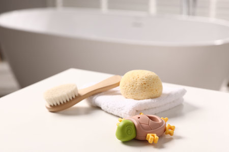 Baby bath accessories on white table in bathroom, closeupの写真素材