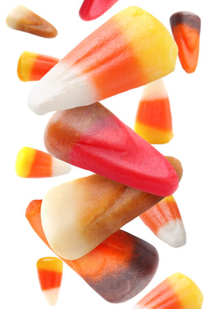 Sweet jelly candies falling against white background