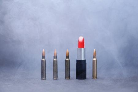 Red lipstick among bullets in smoke on grey backgroundのeditorial素材