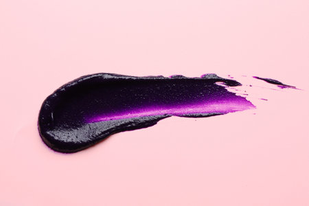 Sample of hair care cosmetic product on pink background, top view