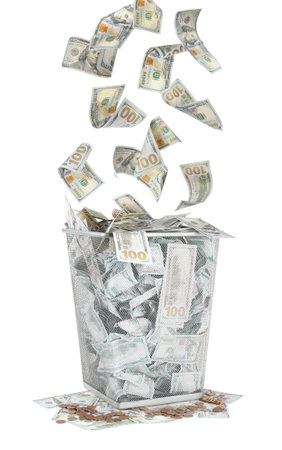 Money falling into trash bin against white backgroundの写真素材