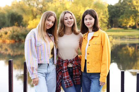 Portrait of teenage girls near lake outdoorsの写真素材