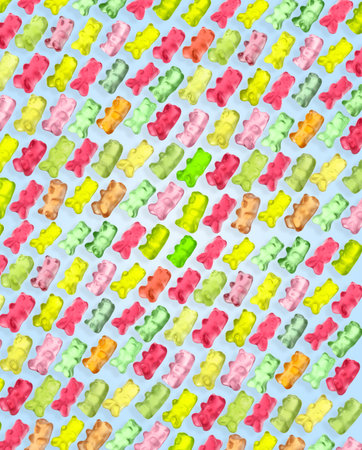 Pattern of sweet gummy bears on light blue background. Jelly candies