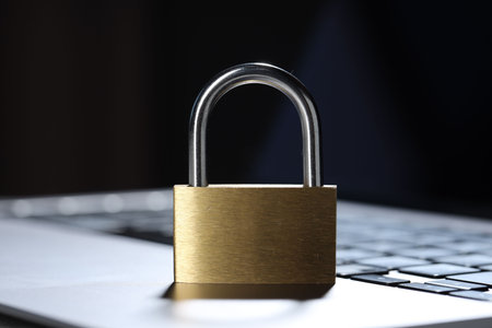 Cyber safety. Metal padlock on laptop, closeup