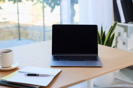 Home workspace. Modern laptop and stationery on wooden desk indoors