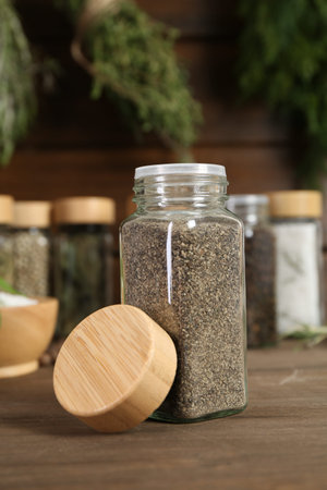 Different spices and jars on wooden table, selective focus