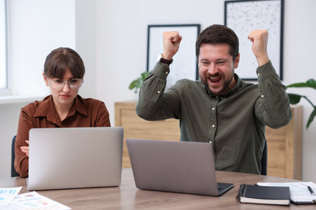 Woman feeling jealous of her colleague's success in office