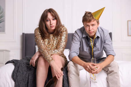 People with alcohol suffering from hangover on bed indoorsの写真素材