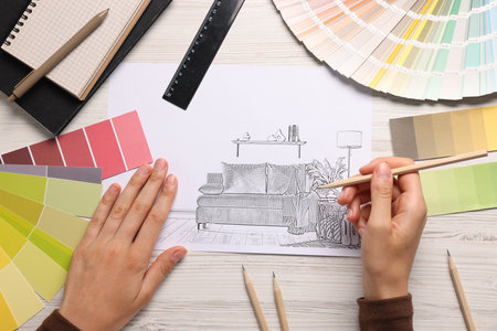 Woman drawing sketch of room interior at white wooden table, top viewのeditorial素材