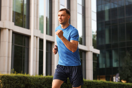 Man in sportswear running on city street