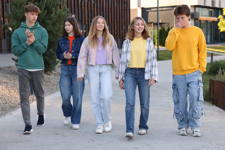 Group of teenagers walking on city streetの写真素材